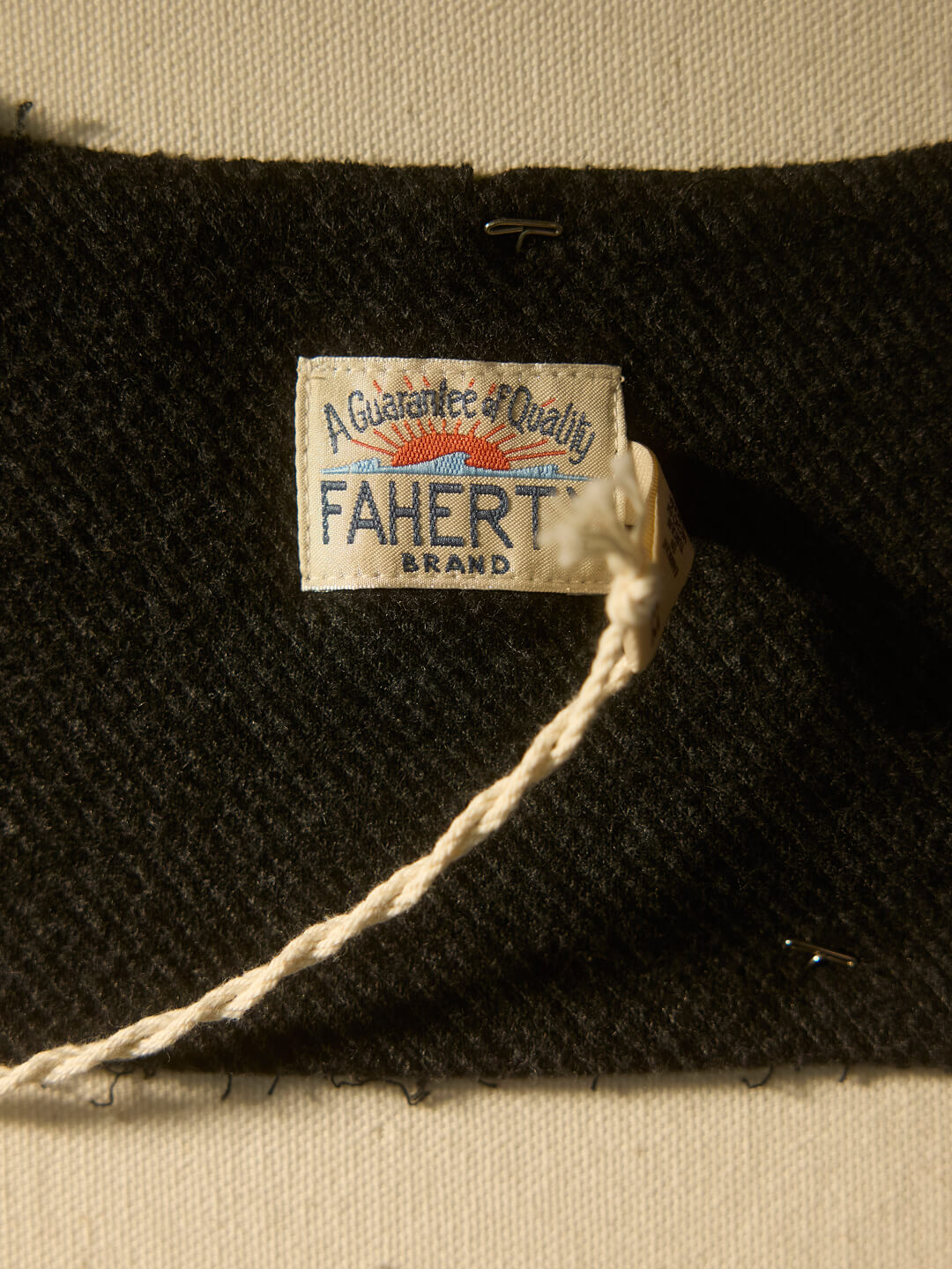 Close up shot of shirt label that says "A Guarantee of Quality"