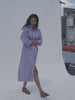 Video of a woman wearing a blue and white striped poplin dress against a white background