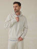 Man wearing a heather grey quarter zip against a beige background