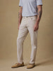 Video of a man wearing beige pants, a light blue polo, and boat shoes against a beige background