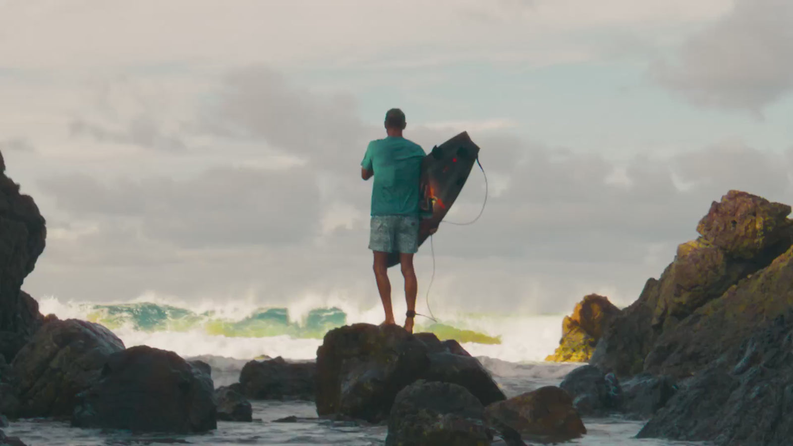 lifestyle footage of surfers on the beach in yron bay australia wearing Faherty swim wear.