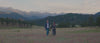 Man and Woman Wearing New Faherty Legend Sweater Shirt and Dress, respectively, while hiking in Estes Park