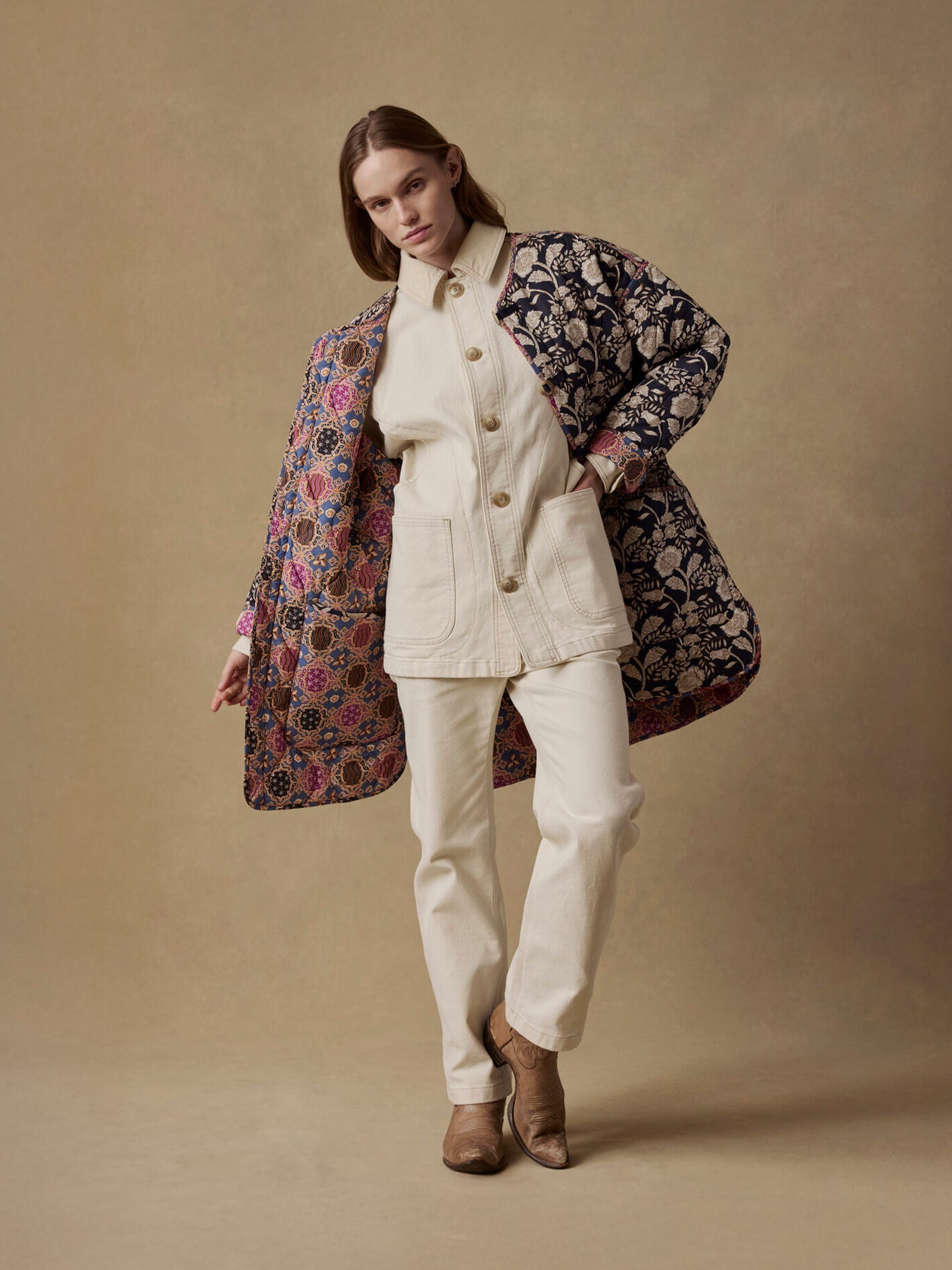 female model wearing reversible quilted jacket on a canvas backdrop
